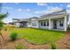 Well-maintained backyard with green lawn, mulch areas, and covered outdoor space at 3051 Bootlace Way, St Cloud, FL 34771