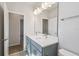 Bathroom featuring a double vanity with undermount sinks, neutral paint, and modern lighting at 3051 Bootlace Way, St Cloud, FL 34771
