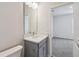 Bathroom features a gray vanity, white countertop, undermount sink, and modern fixtures at 3051 Bootlace Way, St Cloud, FL 34771