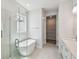 Bright bathroom features a glass shower, soaking tub, and walk-in closet at 3051 Bootlace Way, St Cloud, FL 34771