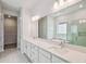 Bright bathroom features double sinks, quartz countertops, large mirror, and separate shower and tub at 3051 Bootlace Way, St Cloud, FL 34771