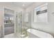 Bright bathroom features a glass shower and soaking tub at 3051 Bootlace Way, St Cloud, FL 34771