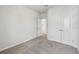 Spacious bedroom with neutral gray carpet and double doors leading to another room at 3051 Bootlace Way, St Cloud, FL 34771