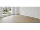 Bright, sun-drenched bedroom featuring wood-look flooring and a large window at 3051 Bootlace Way, St Cloud, FL 34771