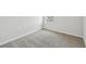 Bright bedroom with neutral gray carpet, window, and white trim in a modern home at 3051 Bootlace Way, St Cloud, FL 34771