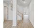 Bright foyer featuring wood-look flooring, a staircase with white banisters, and neutral walls at 3051 Bootlace Way, St Cloud, FL 34771