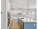 Contemporary kitchen boasts quartz countertops, stainless steel appliances, and an island with a sink at 3051 Bootlace Way, St Cloud, FL 34771