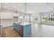 Modern kitchen featuring white cabinets, a blue island, and stainless steel appliances for a chic design at 3051 Bootlace Way, St Cloud, FL 34771