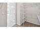 Spacious walk-in closet with wire shelving and carpeted floor near bathroom at 3051 Bootlace Way, St Cloud, FL 34771