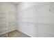 Spacious walk-in closet with wire shelving and carpeted floor at 3051 Bootlace Way, St Cloud, FL 34771