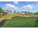 Backyard with a lush lawn, landscaping and view of other homes in the community at 3062 Bootlace Way, St Cloud, FL 34771