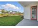 View of the home's backyard with green lawn, landscaping and a view of other homes at 3062 Bootlace Way, St Cloud, FL 34771