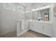 Modern bathroom featuring sleek tiles, double vanity, and frameless glass shower at 3062 Bootlace Way, St Cloud, FL 34771