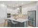 Bright kitchen with stainless appliances, island with breakfast bar, and white cabinetry at 3062 Bootlace Way, St Cloud, FL 34771