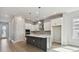 Modern kitchen featuring a spacious island with seating and stainless steel appliances at 3062 Bootlace Way, St Cloud, FL 34771