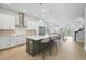 Open-concept kitchen with a large island, modern appliances, and seamless flow to the dining area at 3062 Bootlace Way, St Cloud, FL 34771