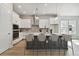 Modern kitchen featuring a spacious island with seating and stainless steel appliances at 3062 Bootlace Way, St Cloud, FL 34771