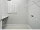 Bright laundry room featuring storage cabinets, a folding counter and a wire shelf at 3062 Bootlace Way, St Cloud, FL 34771