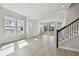 Bright living room and dining area with light flooring and staircase to the second floor at 3062 Bootlace Way, St Cloud, FL 34771