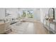 Bright living room with hardwood floors, neutral decor, and large windows at 3062 Bootlace Way, St Cloud, FL 34771