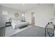 Serene main bedroom with neutral tones, plush carpet, and ensuite bathroom entrance at 3062 Bootlace Way, St Cloud, FL 34771