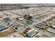 Aerial view of a new community with numerous homes, a pool, and surrounding landscape at 5753 Wallis Ln, St Cloud, FL 34771