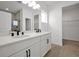 Double vanity bathroom with white cabinets and marble shower at 5753 Wallis Ln, St Cloud, FL 34771