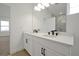 Double vanity bathroom with white cabinets and marble shower at 5753 Wallis Ln, St Cloud, FL 34771