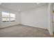 Spacious bedroom with neutral carpeting and large window at 5753 Wallis Ln, St Cloud, FL 34771