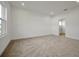 Spacious bedroom with neutral carpeting and door to bathroom at 5753 Wallis Ln, St Cloud, FL 34771