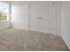 Bright bedroom with neutral carpet and double door closet at 5753 Wallis Ln, St Cloud, FL 34771