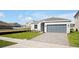 New construction home exterior with gray siding and a gray garage door at 5753 Wallis Ln, St Cloud, FL 34771