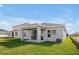 Single-story home with covered patio and grassy yard at 5753 Wallis Ln, St Cloud, FL 34771