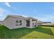 Single-story home with covered patio and grassy yard at 5753 Wallis Ln, St Cloud, FL 34771
