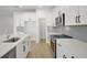 Modern kitchen with stainless steel appliances and white cabinetry at 5753 Wallis Ln, St Cloud, FL 34771