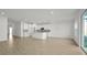 Modern kitchen with white cabinets, center island, and tile floors at 5753 Wallis Ln, St Cloud, FL 34771