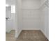 Spacious walk-in closet with wire shelving and neutral carpet at 5753 Wallis Ln, St Cloud, FL 34771