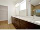Double vanity bathroom with dark cabinetry and quartz countertops at 5783 Greenery Ln, St Cloud, FL 34771