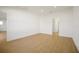 Bright bedroom with wood-look tile flooring, and access to another room at 5783 Greenery Ln, St Cloud, FL 34771