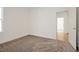 Well-lit bedroom with carpeted floor and access to another room at 5783 Greenery Ln, St Cloud, FL 34771