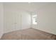 Bright bedroom featuring neutral carpeting and double door closet at 5783 Greenery Ln, St Cloud, FL 34771