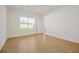Spacious bedroom with light walls and wood-look tile flooring at 5783 Greenery Ln, St Cloud, FL 34771