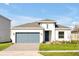 One-story home with gray garage door and landscaped yard at 5783 Greenery Ln, St Cloud, FL 34771