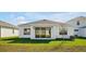 Modern house exterior featuring a covered patio and well-manicured lawn at 5783 Greenery Ln, St Cloud, FL 34771