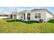 Single-story house with covered patio and a lush green lawn at 5783 Greenery Ln, St Cloud, FL 34771