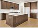 Spacious kitchen island with dark wood cabinets at 5783 Greenery Ln, St Cloud, FL 34771
