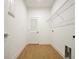 Laundry room with wood-look tile floor and shelving at 5783 Greenery Ln, St Cloud, FL 34771