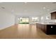 Open concept living room and kitchen with wood floors at 5783 Greenery Ln, St Cloud, FL 34771