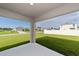 Covered back patio offers views of the spacious, grassy backyard at 684 Se 65Th Ter, Ocala, FL 34472