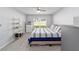 Bedroom with a ceiling fan, bright window, and bed with striped comforter at 684 Se 65Th Ter, Ocala, FL 34472